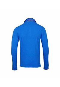  långärmad polo tröja i livlig blå färg, med en ribbad krage som har röd text "SINCE 1890" och kontrasterande svarta detaljer på ärmsluten.