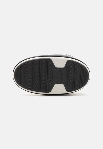 Zwarte rubberen sneakerzool met een gestructureerde grip, voorzien van ronde patronen en een contrasterende witte middenzool. Stevige en vlakke vormgeving.