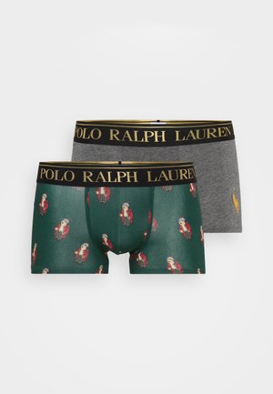 Due coppie di boxer: una verde con un motivo di personaggi dei cartoni animati in abbigliamento invernale e una grigia uniforme. Entrambi presentano un elastico nero con testo dorato.
