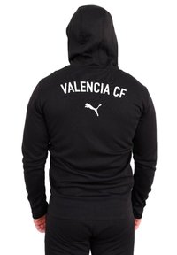 Sudadera con capucha negra de manga larga, con "VALENCIA CF" en texto blanco y un pequeño logo blanco de Puma en la parte posterior.