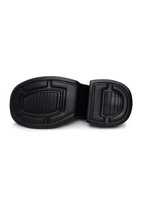 Black rubber sole with textured patterns. Features a semi-rounded shape and reinforced heel for added grip and durability.