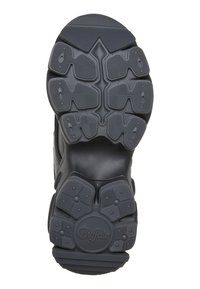 Semelle de chaussure noire avec motifs de grip texturés et le mot "Buffalo" embossé près de la zone du talon.