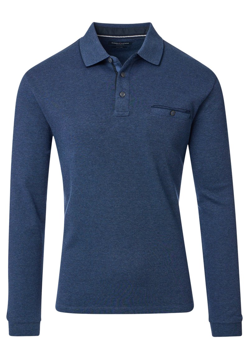 Tummansininen pitkähihainen polo paita, jossa on klassinen kaulus, nappilista ja rintatasku. Valmistettu teksturoidusta puuvillakankaasta.