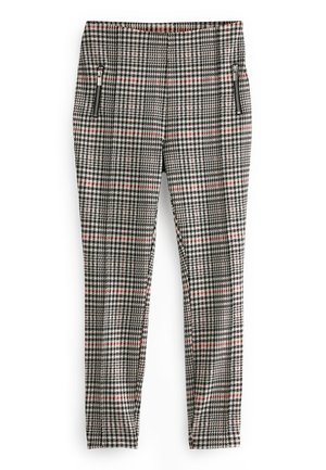 Pantalon slim avec motif pied-de-poule noir, blanc et rouge et poches zippées noires sur les deux hanches sur fond blanc.