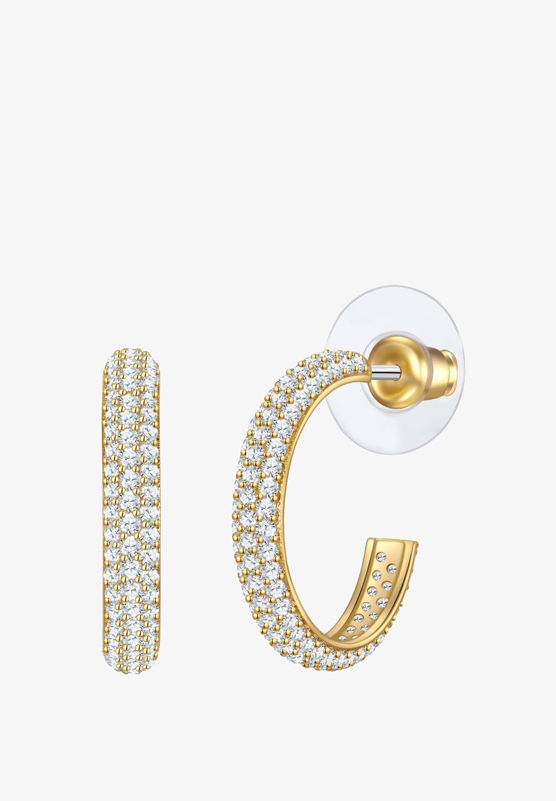 Aukso žiedo auskarai, puošti skaidriais kristalais, turintys lygų, lenktą dizainą ir skaidrų pagrindą saugiam dėvėjimui.