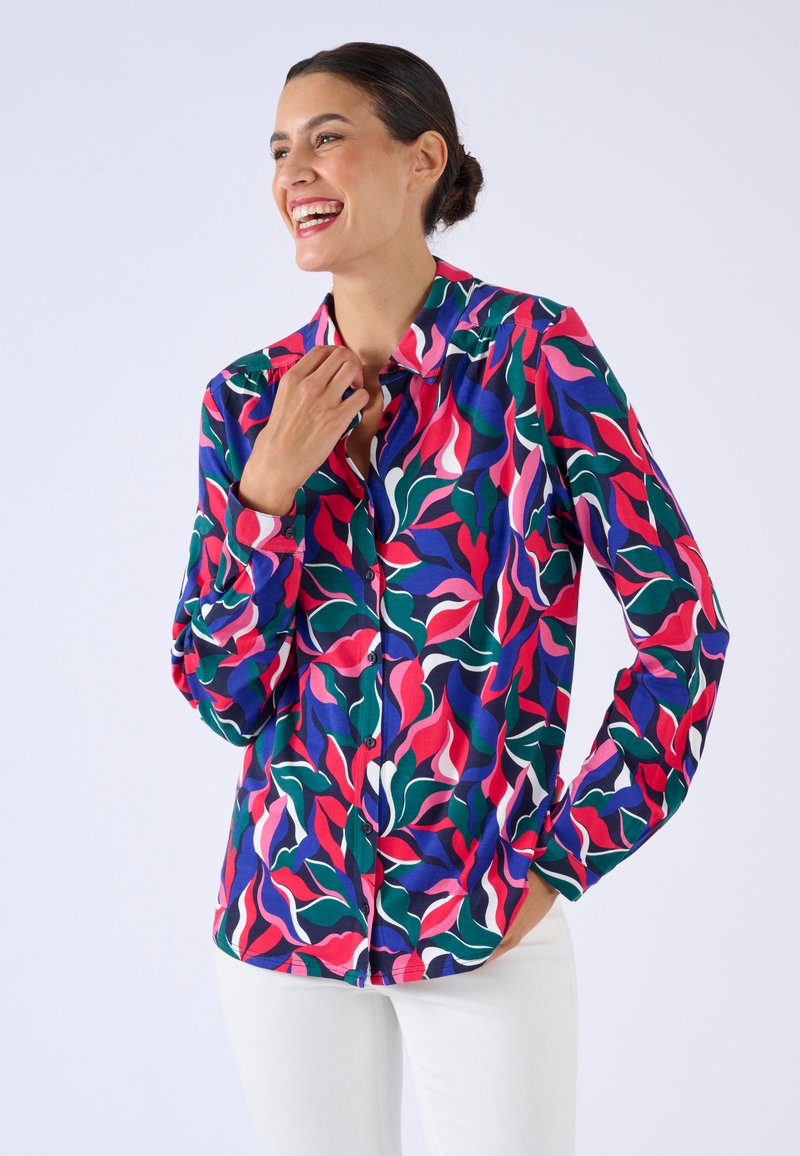 Kleurrijk overhemd met knopen, voorzien van een bloemmotief in roze, groen en blauw. Gemaakt van zacht materiaal met lange mouwen en een kraag.