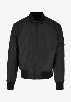 Chaqueta bomber negra con cierre de cremallera, puños y dobladillo acanalados, y un bolsillo lateral. Fabricada con un tejido suave y ligero.