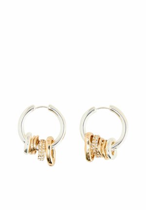 Gold and silver hoop earrings featuring multiple interlinked rings, including one accented with clear rhinestones, smooth and shiny textures.