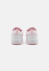 White and pink sneakers with a textured upper, rounded shape, padded collar, and prominent "PUMA" logo on the heel. Reinforced back tab.