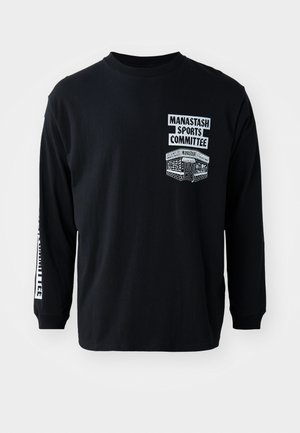 Black long-sleeve t-shirt with crew neck. Features white printed graphics: "Manastash Sports Committee" and a design on the left chest.