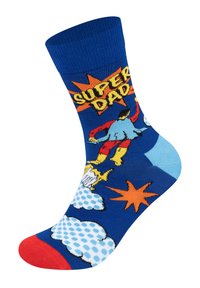 Modrá ponožka s komiksovým nápisem "Super Táta", barevnou superhrdinskou grafikou a hravými vzory, s červenou špičkou a světle modrými akcenty.