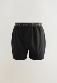 Schwarze Boxershorts aus Baumwolle, mit einem elastischen Bund und dem grauen 'NEXT'-Logo. Enthält ein Vorderknopfdetail.