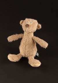 Light brown plush teddy bear with floppy arms and legs, dark nose, and white eyes against a black background.
