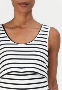 Black and white striped sleeveless top with a ribbed texture and a rounded neckline, featuring a layered design at the hem.