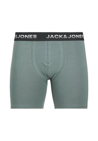 Groene katoenen boxershorts met een zwarte elastische tailleband waarop "JACK & JONES" in witte letters staat. Glad materiaal en een aansluitend ontwerp.