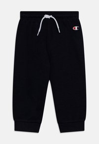 Pantalones deportivos negros de mezcla de algodón, con una cinturilla elástica y cordón blanco, puños ajustados y un pequeño logo en el lado izquierdo.
