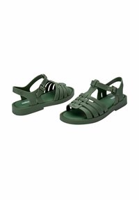 Zielone gumowe sandały z plecionym wzorem i paskiem na kostkę. Płaska podeszwa z teksturowanymi krawędziami. Wygodne do noszenia na co dzień.