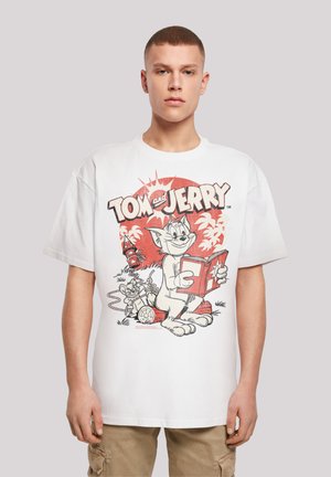 White cotton T-shirt featuring a graphic print of cartoon characters Tom and Jerry, with red and black accents in a vintage style.