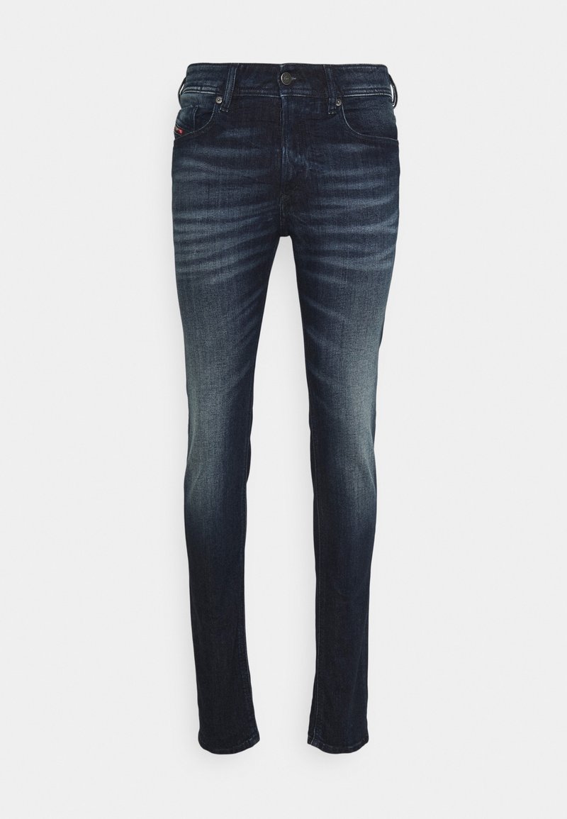 Mörkblå jeans med en urtvättad look, slim fit, fem fickor och metallknapplås. Tillverkade av denimtyg med synliga söm detaljer.
