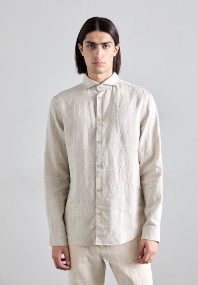 Chemise en lin gris clair avec un devant à boutons, des manches longues et un col classique. Dotée de boutons naturels et d'une coupe décontractée.