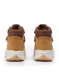 Brown suede and mesh hiking boots with a padded collar, round laces, and a textured rubber outsole. Features dual eyelets for fit adjustment.