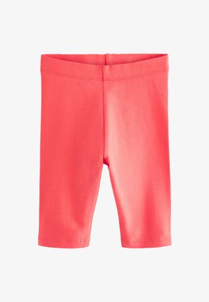 Koraļļu krāsas stiepjamās legingi no mīksta kokvilnas maisījuma, ar gludu vidukļa joslu un potītes garuma griezumu bez jebkādiem rotājumiem vai rakstiem.