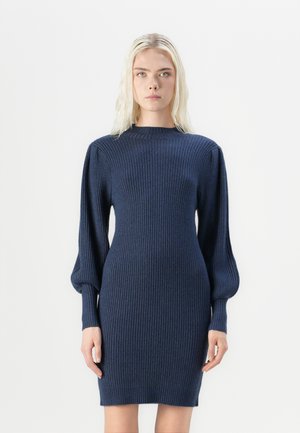 Marineblå ribbestrikket kjole med høy hals og puffede lange ermer, tettsittende silhuett og midt-lår lengde. Jevn tekstur og stretchy materiale.