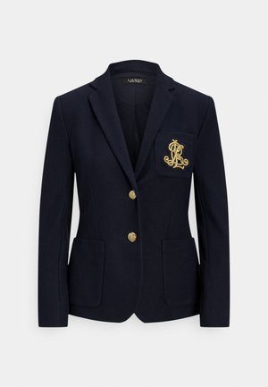 Navy blazer made of textured fabric, featuring a single-button closure, two front pockets, and a gold embroidered logo on the chest pocket.