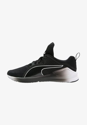 Zapatilla deportiva negra con parte superior de malla, cierre de cordones, logotipo blanco en el lateral y suela con degradado de gris a blanco con lengüeta en el talón.
