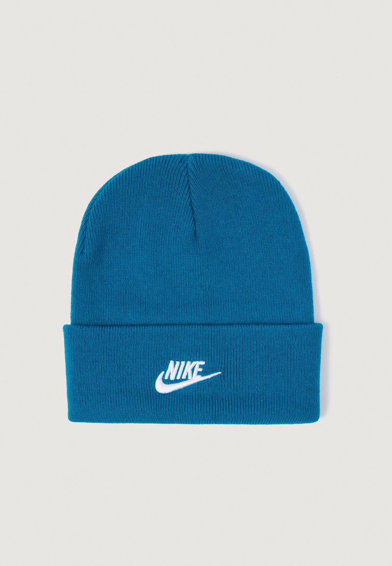 Modra pletena kapa z zavihanjem. Na sprednji strani se nahaja belo Nike logo. Material ima mehak, rebrast teksturo.