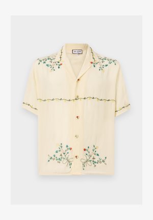 Camicia a maniche corte di colore giallo chiaro, realizzata in tessuto morbido, con motivo floreale ricamato colorato, bottoni e un design del collo rilassato.