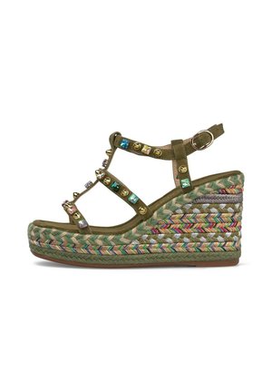 Olive green wedge sandal with multicolored braided platform sole, gold studs, colorful gems on straps, and adjustable ankle buckle.