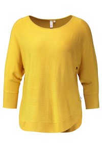 Gelber Pullover mit rundem Ausschnitt und Dreiviertelangärmeln. Weicher Stoff, lockere Passform und abgerundeter Saum am Boden.