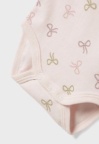 Light pink cotton bodysuit featuring small bows in shades of green and lavender. Includes snap closures at the bottom and soft ribbed edges.