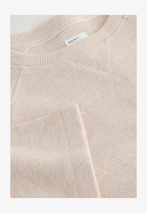 Svetloružová rebrovaná dlhá mikina s viditeľným šitím a značkovou etiketou "NEXT" na golieri.