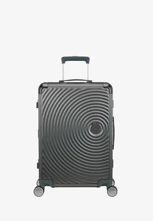 Valise rigide noire avec motif de cercles concentriques, poignée télescopique, poignée latérale et quatre roues pivotantes.