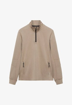 Beżowy sweter z pół-zamkiem i kołnierzem, z dwoma bocznymi kieszeniami na zamek oraz teksturowanym materiałem. Posiada wzmocnione szwy na ramionach.