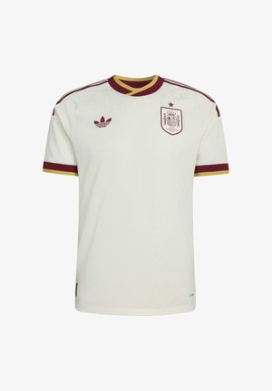 Maillot de foot blanc avec bordures rouges et jaunes, arborant un blason d'équipe avec une étoile sur la poitrine et le logo Adidas sur le côté droit.