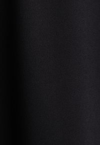 Schwarzer Stoff mit einer glatten, matten Textur. Nahaufnahme zeigt ein einheitliches Erscheinungsbild ohne Muster oder sichtbare Details.