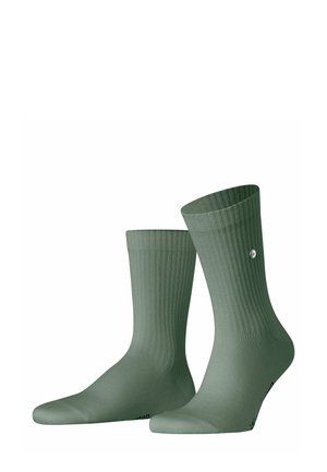 Grüne Baumwollsocken mit gerippter Textur, mittelgroße Länge, abgerundete Zehen und einem kleinen Logodetail an der Seite.