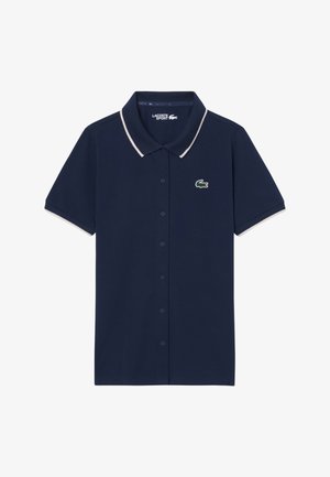 Polo a maniche corte blu navy con bottoni, bordi bianchi su colletto e maniche, con logo coccodrillo verde sul petto.