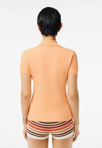 Lacoste Piké - orange clair ixy