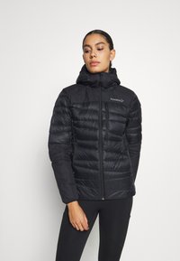 Black puffer jacket with a zip front and hood. Features quilted design, elastic cuffs, and subtle branding on the left chest.