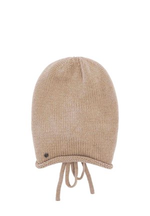 Beige knitted winter hat with ties at the chin and a small round metal logo on the side.