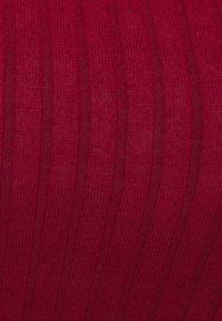 Czerwony materiał o pionowej żebrowanej teksturze i subtelnej połysku, tworzący głębię. Gładkie wykończenie z różnorodnym odbiciem światła na powierzchni.