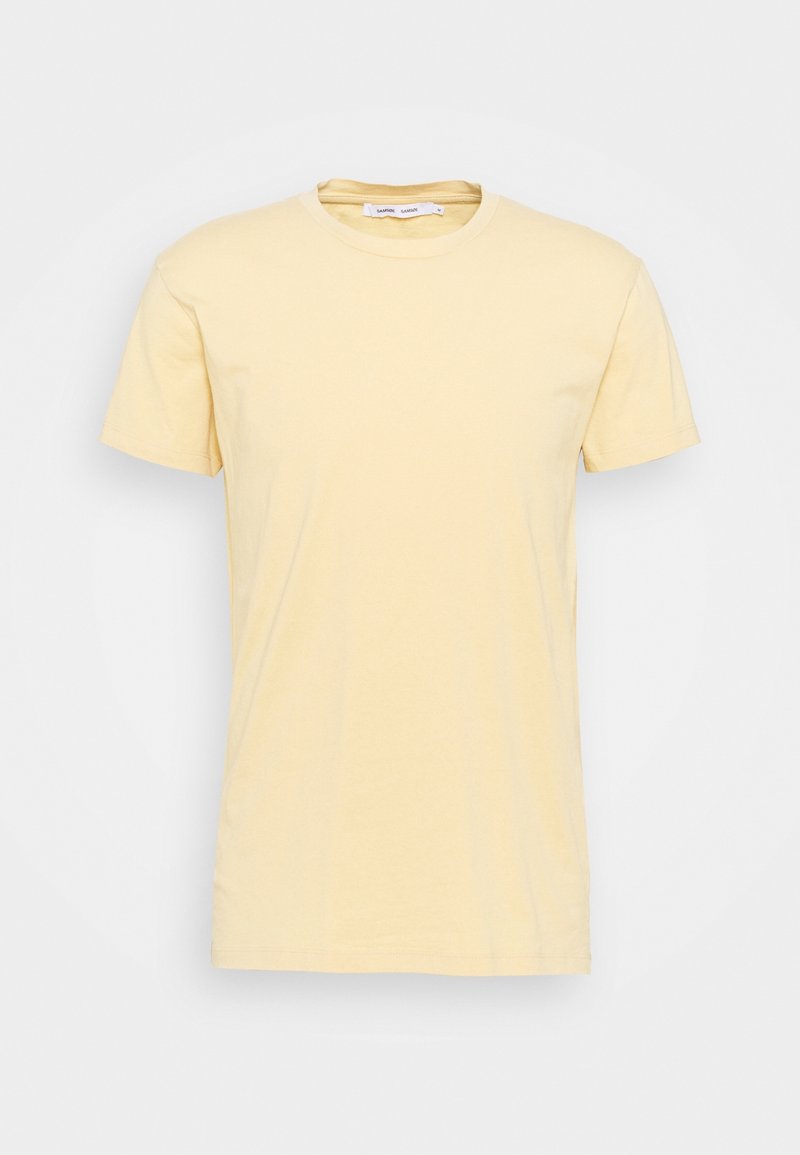 T-shirt homme uni à manches courtes et col rond en jaune pastel clair, présenté sur fond blanc.
