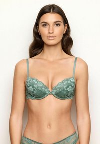 Lace push-up bra in muted green with contoured cups, adjustable straps, and scalloped edges, featuring floral patterns throughout.