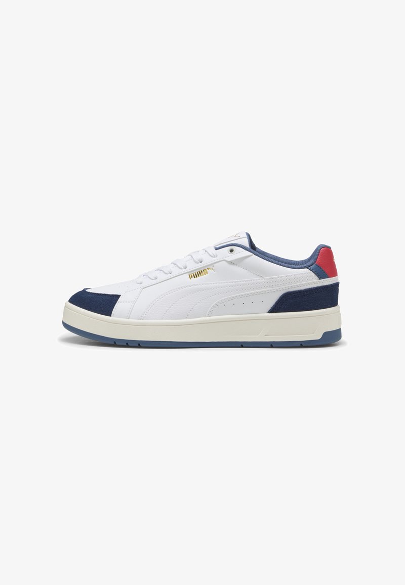 Valged sneakers tumesiniste sametist aksentide ja punase kanna tõstukiga. Omab kuldset logo, siledat nahkust ülemist osa ja kummist tallat, millel on sinine äär.