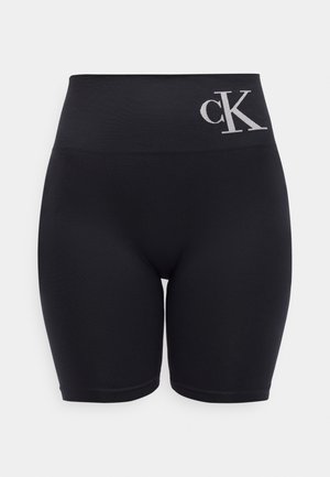 Mustad kõrge vöökohaga rattapüksid laiade vööde ja vasakul esiküljel valge "cK" logoga.