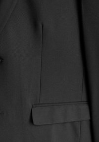 Black suit jacket fabric featuring a smooth texture, tailored design, and a side pocket cap with clean, sharp lines and absence of embellishments.